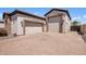 Attached three-car garage with stone accents, offering ample parking and curb appeal at 18036 W San Miguel Ave, Litchfield Park, AZ 85340
