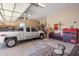 Spacious garage with storage, tool chests, and a truck, offering ample space for vehicles and projects at 18036 W San Miguel Ave, Litchfield Park, AZ 85340