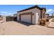 Garage exterior showcases stonework and a brick paver driveway, with manicured landscaping, adding curb appeal at 18036 W San Miguel Ave, Litchfield Park, AZ 85340
