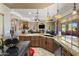 Open kitchen with island, granite countertops, and stainless-steel appliances overlooking the Gathering room at 18036 W San Miguel Ave, Litchfield Park, AZ 85340