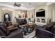 Inviting living room featuring a stone fireplace and an open bar area with pendant lighting at 18036 W San Miguel Ave, Litchfield Park, AZ 85340