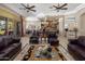 Open-concept living room with view of a dining area and kitchen; complete with stone fireplace at 18036 W San Miguel Ave, Litchfield Park, AZ 85340