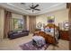 Spacious main bedroom with sitting area, tray ceiling, and luxurious furnishings and decor at 18036 W San Miguel Ave, Litchfield Park, AZ 85340