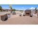 Outdoor kitchen boasts built-in grill, mini fridge, and stone fireplace at 18036 W San Miguel Ave, Litchfield Park, AZ 85340
