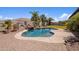 Beautiful backyard pool with a stone waterfall and patio, ideal for relaxation and entertaining at 18036 W San Miguel Ave, Litchfield Park, AZ 85340