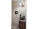Elegant powder room with vessel sink, granite countertop, and decorative lighting fixture at 18036 W San Miguel Ave, Litchfield Park, AZ 85340
