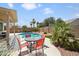 Inviting backyard featuring a pool, desert landscaping, and a patio set for outdoor dining at 18242 W Stinson Dr, Surprise, AZ 85374