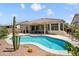 Backyard pool featuring desert landscaping, a covered patio, and a view of the home's exterior at 18242 W Stinson Dr, Surprise, AZ 85374