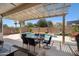 Backyard featuring a sparkling pool, desert landscaping, and a covered patio with seating at 18242 W Stinson Dr, Surprise, AZ 85374