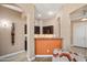Stylish bar area with dark wood cabinetry, a counter, and elegant lighting at 18242 W Stinson Dr, Surprise, AZ 85374