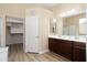 This bathroom has a double sink vanity, a walk-in closet, and a glass-enclosed shower at 18242 W Stinson Dr, Surprise, AZ 85374