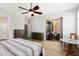 Bright bedroom with a ceiling fan, wood flooring, and sliding glass doors leading to a patio at 18242 W Stinson Dr, Surprise, AZ 85374