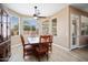 Bright dining room with a wood table, chairs, and large windows providing natural light at 18242 W Stinson Dr, Surprise, AZ 85374