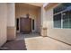 Covered front entrance with double doors, sidelights, and a charming outdoor chandelier at 18242 W Stinson Dr, Surprise, AZ 85374