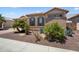 Charming single-story home featuring desert landscaping and a tile roof at 18242 W Stinson Dr, Surprise, AZ 85374