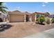 Inviting single-story home with a desert landscape, a tile roof, and a spacious three-car garage at 18242 W Stinson Dr, Surprise, AZ 85374