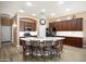 Island kitchen featuring dark wood cabinets, white countertops, and seating at the island at 18242 W Stinson Dr, Surprise, AZ 85374