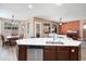 Gourmet kitchen with a central island, stainless steel appliances, and adjacent dining area at 18242 W Stinson Dr, Surprise, AZ 85374