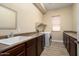 Functional laundry room featuring storage cabinets, countertop space, and modern appliances at 18242 W Stinson Dr, Surprise, AZ 85374
