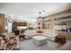 Bright living room featuring a white leather sectional sofa and decorative accents in neutral earth tones at 18242 W Stinson Dr, Surprise, AZ 85374