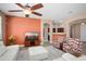 Spacious living room featuring a ceiling fan, wood floors, and an adjacent bar area at 18242 W Stinson Dr, Surprise, AZ 85374
