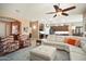 Open-concept living space with cozy armchairs and a white leather sectional sofa overlooking the kitchen at 18242 W Stinson Dr, Surprise, AZ 85374