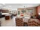 Open living space featuring a white leather sofa, wood floors, and kitchen island with seating at 18242 W Stinson Dr, Surprise, AZ 85374