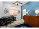 Home office featuring a desk, cabinet, and a blue accent wall at 18242 W Stinson Dr, Surprise, AZ 85374
