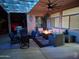 Spacious covered patio area featuring a dining set, grill, and comfortable outdoor seating at 18242 W Stinson Dr, Surprise, AZ 85374