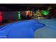 An outdoor pool with colored lighting and patio furniture for evening enjoyment at 18242 W Stinson Dr, Surprise, AZ 85374