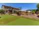 Expansive backyard featuring artificial turf, a basketball hoop, cozy lounge areas, and a charming hammock at 19427 W Colter St, Litchfield Park, AZ 85340