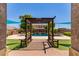 Beautiful backyard view through a pergola to the pool and lounge area, blending comfort and entertainment at 19427 W Colter St, Litchfield Park, AZ 85340