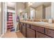Bathroom featuring double sinks, warm-toned tile, and neutral decor at 19427 W Colter St, Litchfield Park, AZ 85340