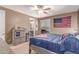 Well-lit bedroom boasts a ceiling fan and decorative American flag accent at 19427 W Colter St, Litchfield Park, AZ 85340