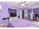 Modern bedroom featuring purple accents, ceiling fan, and neutral carpet at 19427 W Colter St, Litchfield Park, AZ 85340