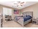 Comfortable bedroom featuring a ceiling fan and a decorative American flag at 19427 W Colter St, Litchfield Park, AZ 85340