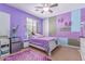 Stylish bedroom with a colorful accent wall, ceiling fan, and cozy furnishings at 19427 W Colter St, Litchfield Park, AZ 85340