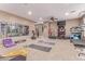 A large, well-lit home gym with various exercise equipment, weights, mirrored walls, and carpeted flooring at 19427 W Colter St, Litchfield Park, AZ 85340