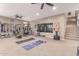 A well-equipped home gym with exercise machines, free weights, carpet flooring, and mirrored walls at 19427 W Colter St, Litchfield Park, AZ 85340