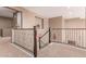 Second-floor hallway with decorative iron railings and view to the floor below at 19427 W Colter St, Litchfield Park, AZ 85340