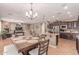 Open kitchen with large island, dark wood cabinetry, and stainless appliances adjacent to dining and living area at 19427 W Colter St, Litchfield Park, AZ 85340