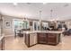 Open kitchen featuring a central island with a sink, stainless steel appliances, and connection to the living area at 19427 W Colter St, Litchfield Park, AZ 85340