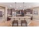 Well-equipped kitchen featuring a large island with barstool seating and stainless steel appliances at 19427 W Colter St, Litchfield Park, AZ 85340