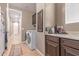 Efficient laundry room with modern appliances, ample counter space, and convenient cabinet storage at 19427 W Colter St, Litchfield Park, AZ 85340