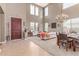 Open-concept living room with a high ceiling, carpeted floor and dining area at 19427 W Colter St, Litchfield Park, AZ 85340