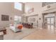 Bright living room featuring a dining area, high ceilings, carpeted floor and a modern chandelier at 19427 W Colter St, Litchfield Park, AZ 85340