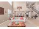 Cozy living room featuring staircase and dining area, high ceilings, carpeted floor and modern furniture at 19427 W Colter St, Litchfield Park, AZ 85340