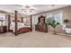 Spacious bedroom featuring a four-poster bed, ceiling fan, and bright windows at 19427 W Colter St, Litchfield Park, AZ 85340