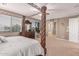 Bright bedroom with a four poster bed, side table and bathroom access at 19427 W Colter St, Litchfield Park, AZ 85340
