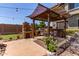 Outdoor kitchen featuring a built-in grill, brick pizza oven, counter space, and a shaded dining area at 19427 W Colter St, Litchfield Park, AZ 85340
